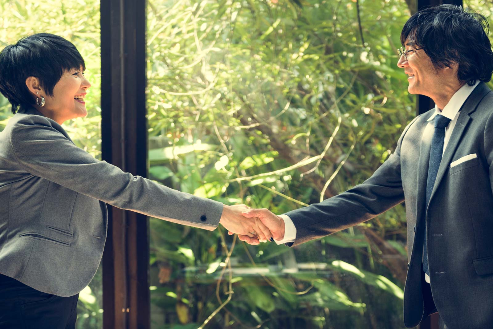 Asian business people shaking hands